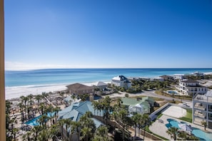A resort with a pool, beach, and ocean view.