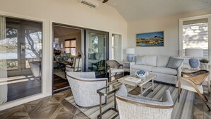 A spacious living room with a sofa, chairs, and a coffee table. There is a painting on the wall and a ceiling fan. - 6 Portside- HEATED Community Pool. Fantastic views of South Beach Marina (Hilton Head Island)