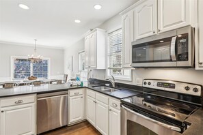 Enjoy cooking in this well-equipped kitchen with a large island, double oven, and dishwasher.