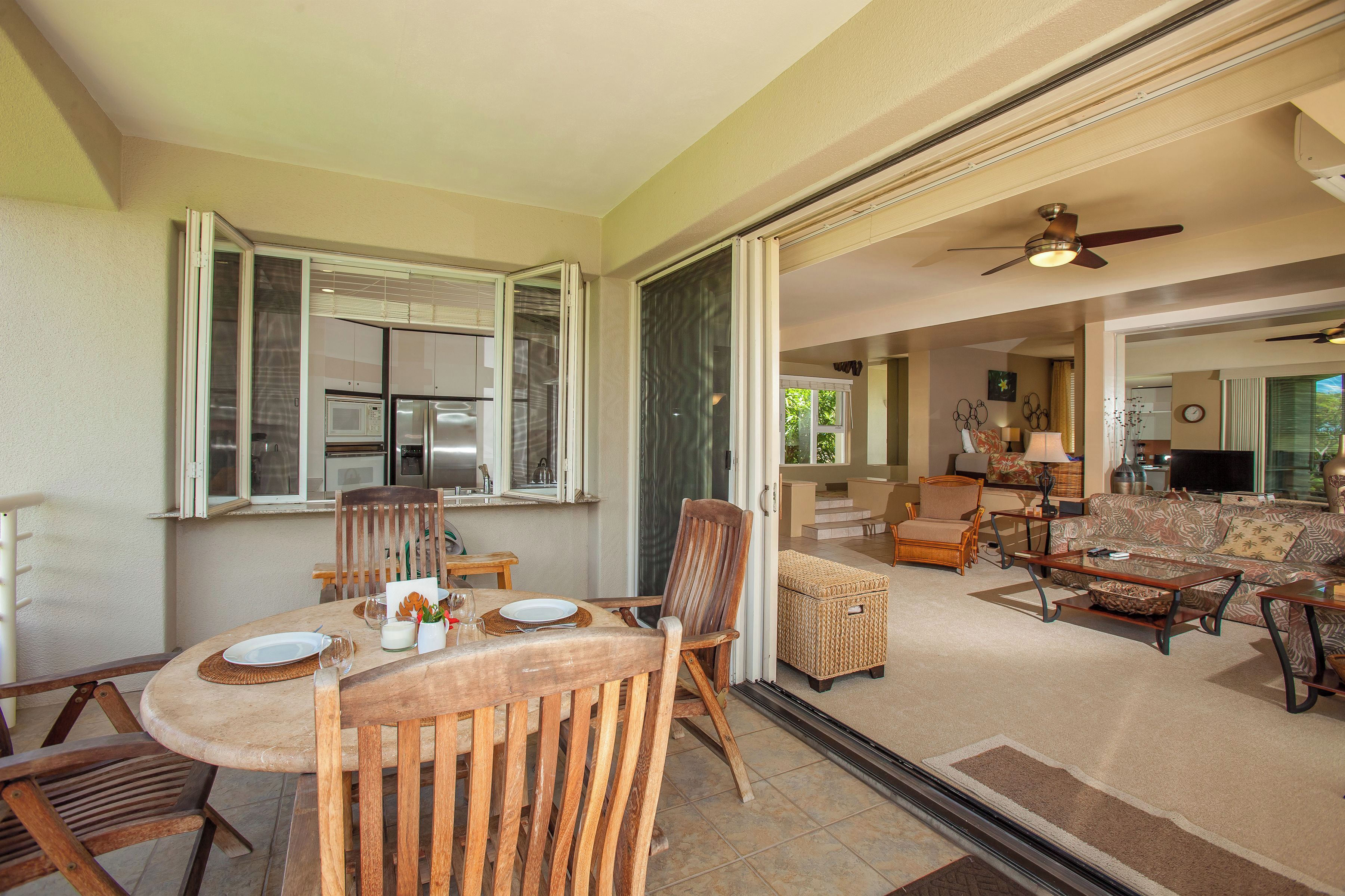 A spacious living area with a dining table, chairs, a sofa, and a television.