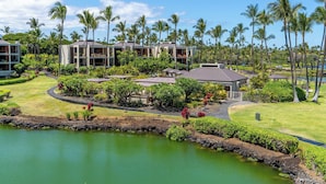 A resort with multiple buildings, a well-maintained lawn, and a body of water. - Gorgeous Oceanfront Terrace Condo - Near Beach Club! (Kamuela)