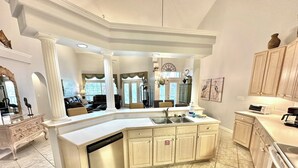 A spacious kitchen with a large island, built-in appliances, and a modern design. - Villa close to beach Includes 6-Seat Golf Cart! 5257 TS (Miramar Beach)