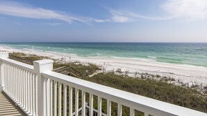 A beach view from a balcony with a white railing, ocean, and clear sky. - Fabulous Gulf Front Home, Gated neighborhood, Double porches, Santa Rosa Beach (Santa Rosa Beach)
