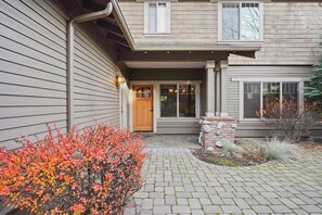 Stunning facade with a central entrance and beautifully landscaped grounds.