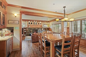 Enjoy meals around the large dining table surrounded by comfortable chairs in this well-appointed kitchen.