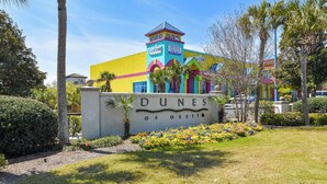 A colorful building with a sign that reads 'DUNES OF DESTIN'.