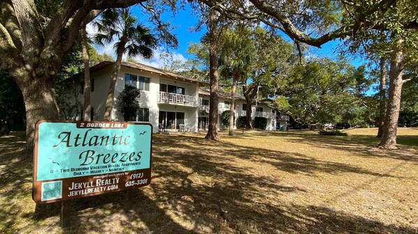 A two-story building with balconies, labeled 'Atlantic Breezes,' located at 2 Borden Lane, offering 8 two-bedroom vacation rental apartments.