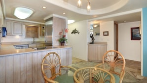 Une cuisine moderne avec un îlot central, des chaises en bois et une table à manger.