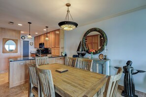 Enjoy meals in this stylish dining area with a large mirror, decorative sculpture, and ample counter space.