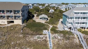 A coastal building with multiple balconies, a beach path, and surrounding vegetation. - GULF FRONT! Pet Friendly! Beach Cottage 30A- Dune Allen Beach (Santa Rosa Beach)