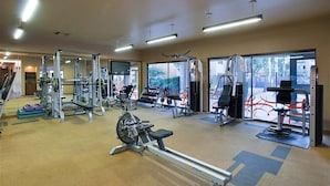 A gym with various exercise equipment, large windows, and a carpeted floor. - Endless Summer Modern 2 Bedroom Condo/ Community Pool/ Jacuzzi/ Scottsdale (Scottsdale)