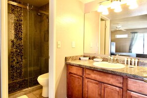 A bathroom with a shower, toilet, and vanity with a mirror. - Endless Summer Modern 2 Bedroom Condo/ Community Pool/ Jacuzzi/ Scottsdale (Scottsdale)