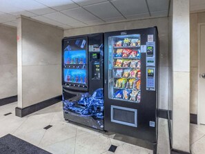 A vending machine with a water dispenser and snack options. - Crystal Tower 407 - Beachfront pool, great amenities & private skywalk to beach! (Gulf Shores)