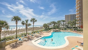 A resort pool with a view of the beach and ocean, surrounded by palm trees and lounge chairs. - Stunning Gulf Views I Luxury Beachfront I Jade East Towers 620 (Destin)
