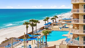 A hotel with a pool, beach view, and multiple balconies. - AMAZING VIEWS! FREE BEACH SERVICE! (Panama City Beach)