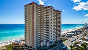 A high-rise hotel with multiple balconies, a beach view, and a pier in the background. - AMAZING VIEWS! FREE BEACH SERVICE! (Panama City Beach)