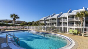 A swimming pool with a white fence, surrounded by a brick patio. - Gulf front townhouse with community pool, incredible views- Blue Mountain Beach (Santa Rosa Beach)