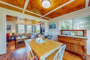 Relax in this open-plan living space with a dining area, kitchen, and comfortable seating.