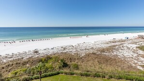 A beach with white sand, a clear blue sky, and a calm sea. - WALK OUT TO POOL FROM FURNISHED PATIO!  Beachside Condo, Just Steps to Beach! (Miramar Beach)
