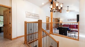 Un escalier avec des rampes en bois et un lustre.