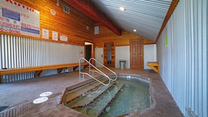 A pool area with a wooden deck, metal railings, and a tiled floor. - Mountain Condo Near Gondola & Village 249 (Mammoth Lakes)