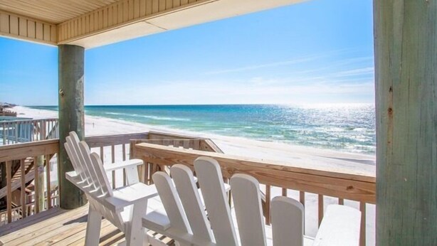 A wooden deck with white chairs overlooking a beach. - Greenwave - Gulf Front, Old Florida Style on Dune Allen Beach (Santa Rosa Beach)