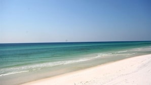 A beach with clear turquoise water and a wide sandy shore. - Greenwave - Gulf Front, Old Florida Style on Dune Allen Beach (Santa Rosa Beach)