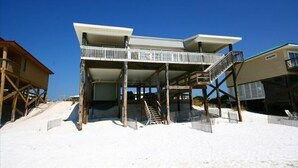 A beachfront property with a two-story structure, a balcony, and a staircase leading to the upper level. - Greenwave - Gulf Front, Old Florida Style on Dune Allen Beach (Santa Rosa Beach)