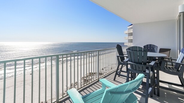 A balcony with a view of the ocean, featuring a table and chairs. - Lighthouse 1112 by Liquid Life (Gulf Shores)