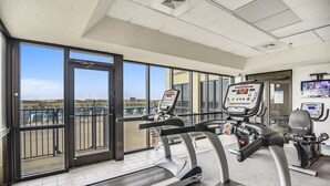 A gym with treadmills, a stationary bike, and a rowing machine. - Phoenix 7 1011 | Gulf Views | Indoor, Outdoor Pools | My Beach Getaways (Orange Beach)