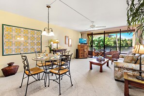 Unwind in your bright, open-concept living space where tropical vibes meet island comfort. Step through the glass doors to your private balcony and take in peaceful garden views.