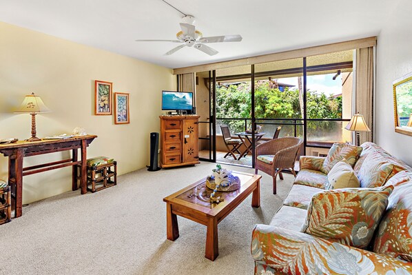 Sink into island comfort in your bright living space, where tropical breezes drift through open balcony doors and greenery beckons beyond your private lanai.