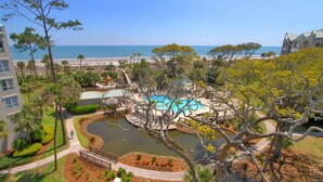 A resort with a swimming pool, a small lake, and a beach view. - 4506 Windsor Court - 5th Floor - Serenity at its best.  AMAZING VIEWS! (Hilton Head Island)