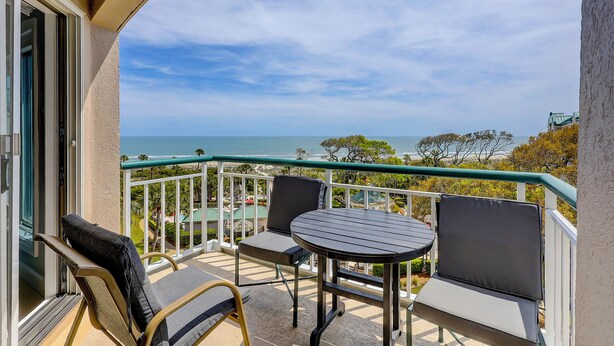 A balcony with a view of the ocean, two chairs, and a small table. - 4506 Windsor Court - 5th Floor - Serenity at its best.  AMAZING VIEWS! (Hilton Head Island)