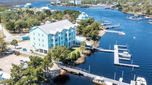 A waterfront property with a large building, docks, and boats. - Waterfront, RIVERS EDGE CONDO #1B-BLDG 2 PRIVATE DOCK and ASSIGNED BOAT SLIP! (Steinhatchee)