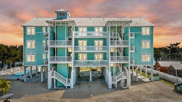 A multi-story building with balconies and a central staircase. - Waterfront, RIVERS EDGE CONDO #1B-BLDG 2 PRIVATE DOCK and ASSIGNED BOAT SLIP! (Steinhatchee)