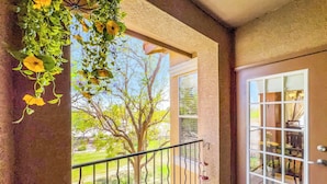 A balcony with a view of a tree and a lawn. - Best 2 Bedroom in Litchfield Park! Hot Community Pool, 1 car garage (Litchfield Park)
