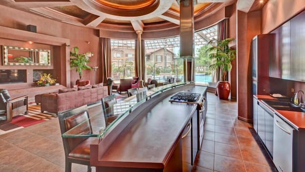 A spacious lobby with a long bar, seating area, and large windows offering views of the outdoors. - Best 2 Bedroom in Litchfield Park! Hot Community Pool, 1 car garage (Litchfield Park)