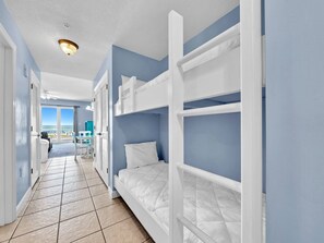 A hotel room with bunk beds, a balcony with a view, and a tiled floor. - 🌊  TWO Beachfront Pools~Covered Parking~1BR Seychelles 207 (Panama City Beach)