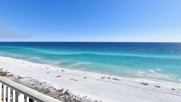 A beach with clear blue water and white sand, viewed from a balcony. - 🌊Gulf Front🌊Onsite Bar and Grill🌊 Silver Beach Towers West 505 (Destin)