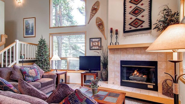A cozy living room with a fireplace, comfortable seating, and decorative wall art. - 3BR+Loft Mountain Townhome Near the Slopes. PRIVATE HOT TUB, Views! CR500 (Breckenridge)