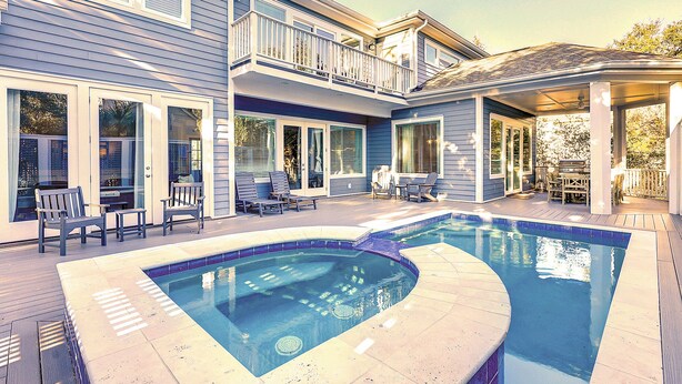 A residential property with a swimming pool, outdoor seating, and a covered patio area. - 52 N. Forest Beach-4th row (176 yard walk) to  ocean w/ elevator & much more! (Hilton Head Island)