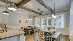 A modern kitchen with granite countertops, wooden chairs, and pendant lighting. - 52 N. Forest Beach-4th row (176 yard walk) to  ocean w/ elevator & much more! (Hilton Head Island)