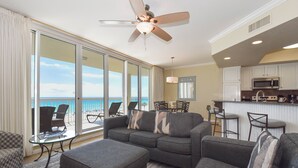 A living room with a sofa, ottoman, and a ceiling fan. - Updated Beachfront Condo w/ Great Views From Private Balcony in Destin! 🌊🌴🐬 (Destin)