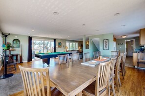 Enjoy meals and games in this room with a large dining table and pool table.