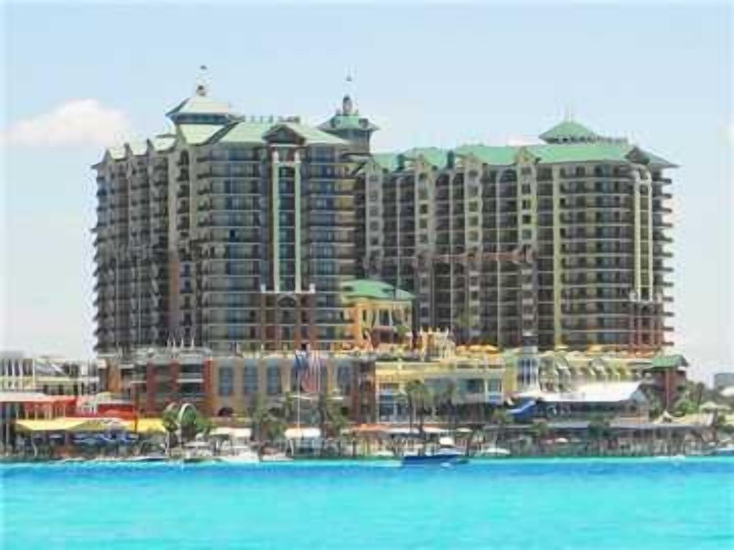 A multi-story hotel with a central courtyard and balconies.