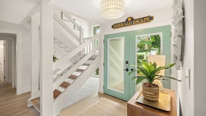 A staircase leading to a door with a sign reading "Emerald Escape". - Beautiful Renovation~Golf Course View~Golf Cart,Free Activities, Fenced Patio (Miramar Beach)