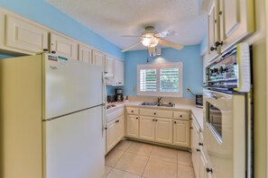 Fridge, stovetop, dishwasher, coffee/tea maker