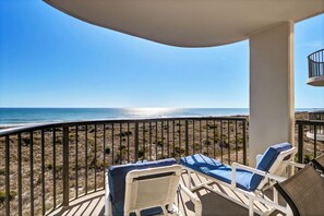 Enjoy the ocean view from this balcony with two lounge chairs.