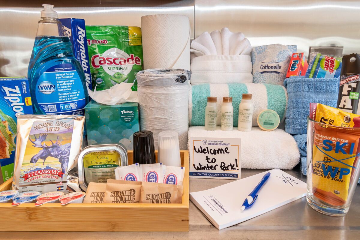 A variety of toiletries and amenities including Dawn dish soap, Cascade toilet paper, and various personal care products.